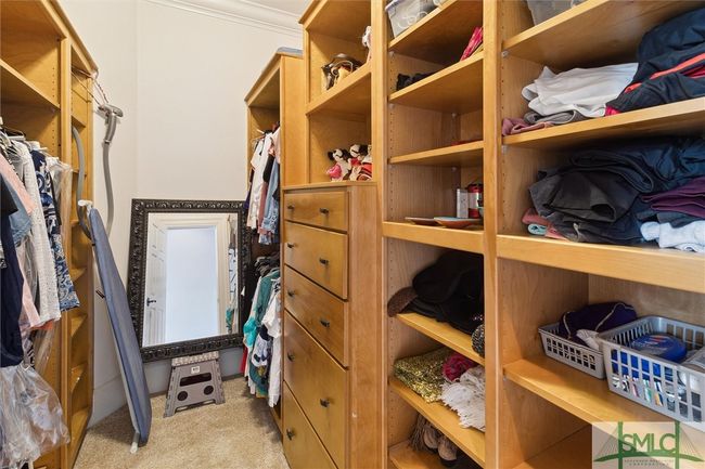 Her closet is complete with built-in shelving and drawers and is located across the hall from the bathrooms. | Image 28