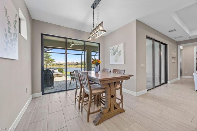 Dining area with a ceiling fan, baseboards, visible vents, and wood finish floors | Image 35