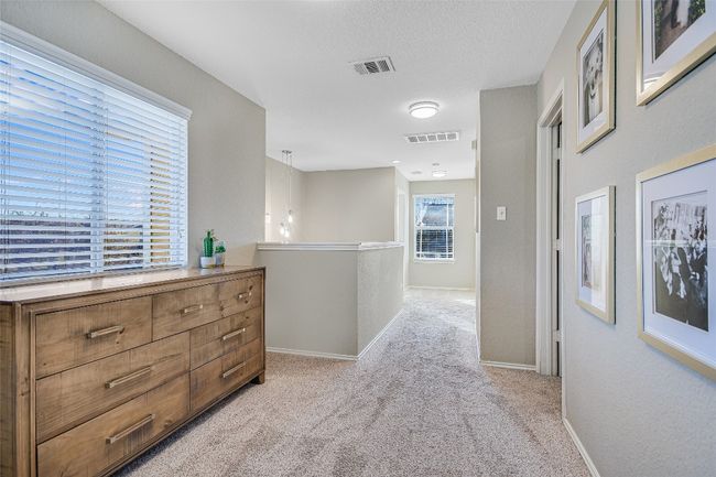 Corridor with light carpet and baseboards | Image 12