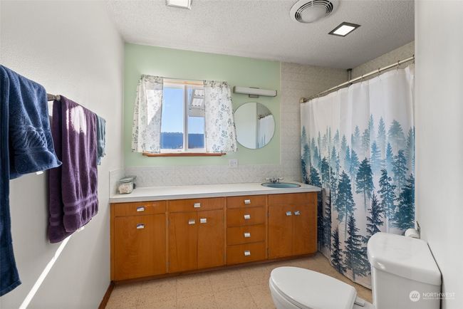 The upper level features a spacious full bath, designed to accommodate the needs of a busy household. With its generous size and thoughtful layout, it provides both comfort and convenience for daily routines | Image 17