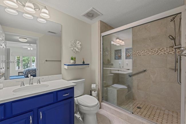Handy seat in large shower plus safety bars. | Image 21