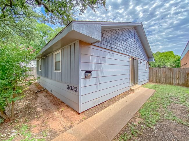 View of side of home featuring crawl space and board and batten siding | Image 4