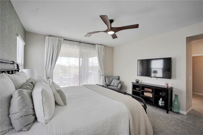 Carpeted bedroom with baseboards, ceiling fan, and visible vents | Image 17