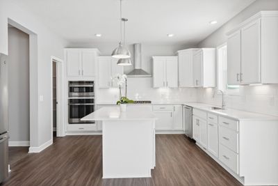 (Photo of Similar home, actual home's finishes will vary) Enjoy entertaining friends and family in this spacious kitchen that features a large center island, quartz countertops and all kitchen appliances included. | Image 2