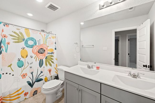 Full bath featuring visible vents, toilet, and a sink | Image 24