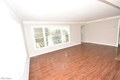 Empty room featuring dark hardwood / wood-style flooring and ornamental molding | Image 3