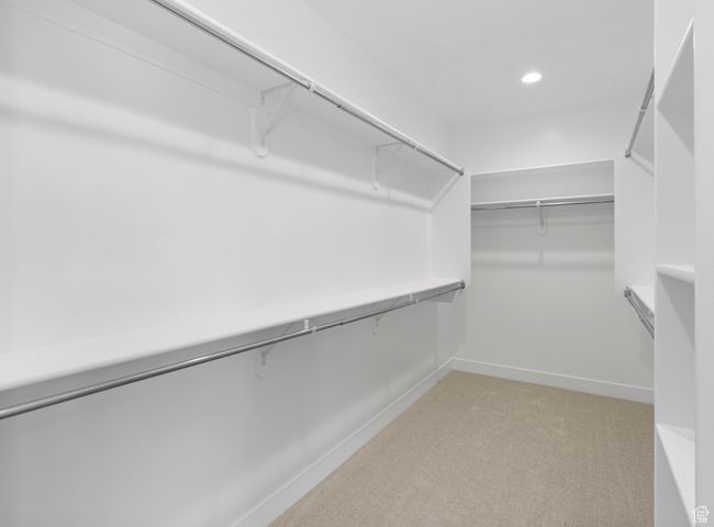 Spacious closet featuring light colored carpet | Image 9
