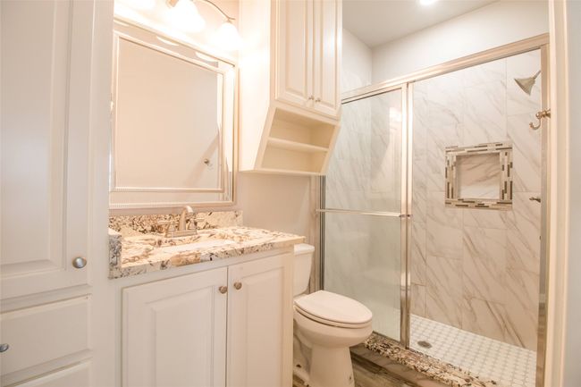Full bath with a marble finish shower and vanity | Image 8