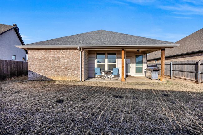 Rear view of property with a patio, brick siding, roof with shingles, and a fenced backyard | Image 30