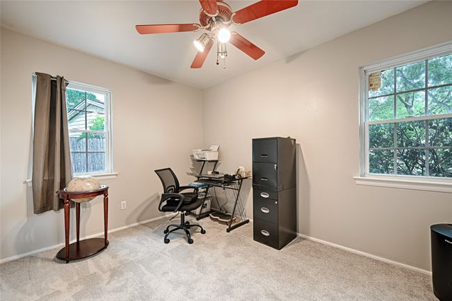 Carpeted bedroom used as home office. | Image 17