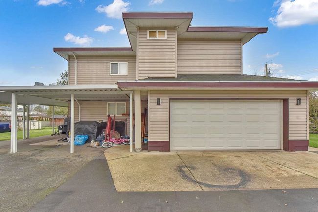 View of front facade featuring an attached garage and driveway | Image 7