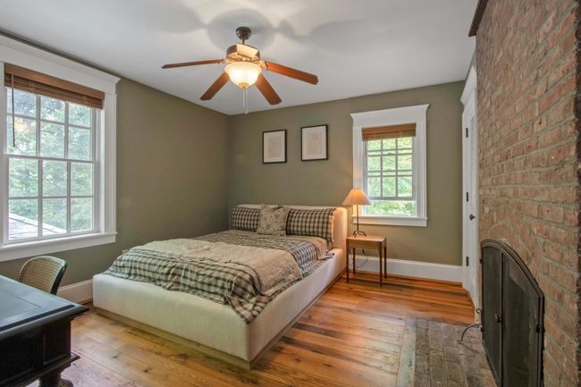 Bedroom with baseboards, hardwood / wood-style floors, and ceiling fan | Image 27