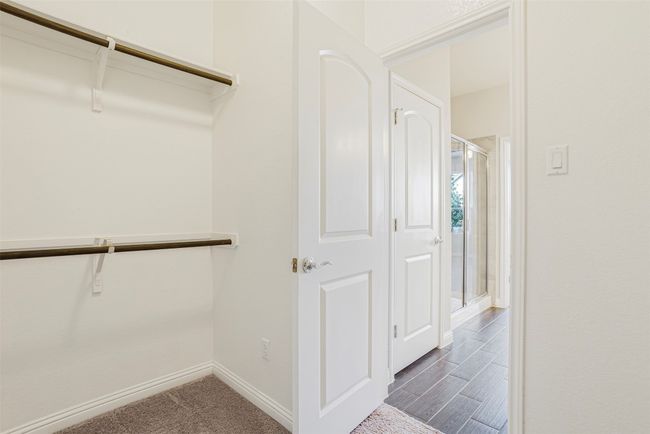 Walk in closet featuring dark wood-type flooring | Image 22