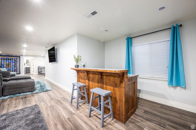 Bar featuring hardwood / wood-style flooring | Image 40
