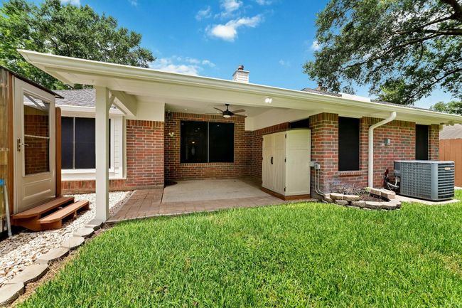 Alternate perspective of the covered backyard patio, showcasing its spacious design and inviting atmosphere for outdoor enjoyment and gatherings. | Image 31