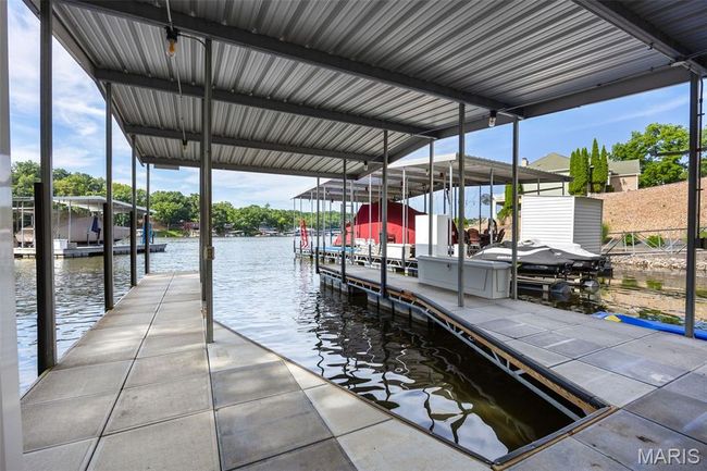 Dock area with a water view and boat lift | Image 35