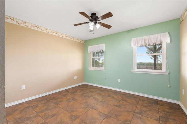Empty room featuring ceiling fan and baseboards | Image 16