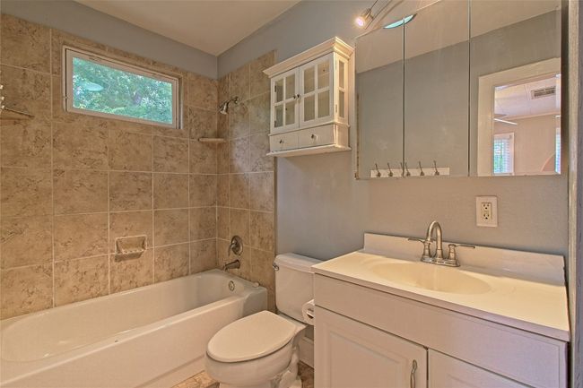 Bathroom featuring vanity and tub / shower combination | Image 23