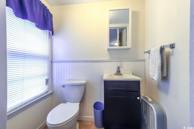 Half bath with vanity, wainscoting, and tile patterned flooring | Image 12