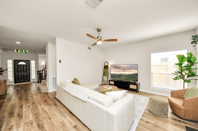 This open-concept living space is all about modern elegance — light, airy, and effortlessly stylish. From the sleek staircase to the gorgeous light-toned flooring, every detail creates a bright and inviting atmosphere you'll love coming home to. | Image 14