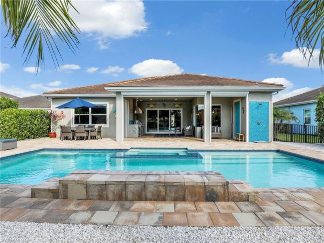 View of swimming pool with ceiling fan and a patio area | Image 35
