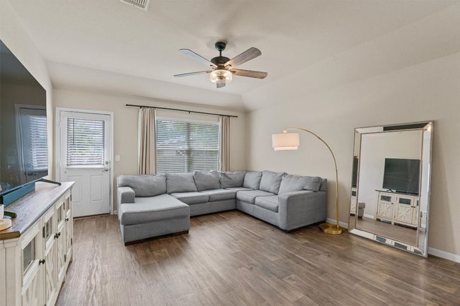 Living room with wood finished floors and ceiling fan | Image 12