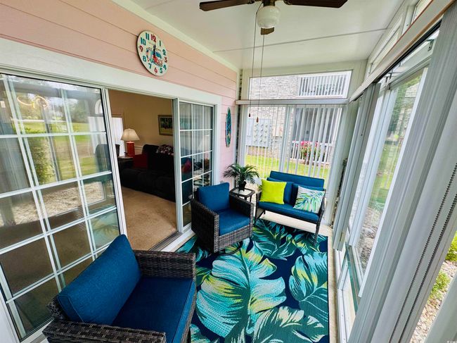 Sunroom / solarium featuring healthy amount of natural light and a ceiling fan | Image 4