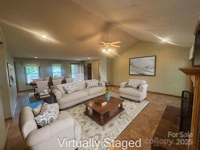 Virtually staged view from sunroom to living area | Image 11
