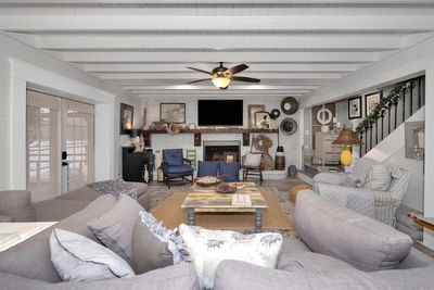 Living Room - LVP flooring, fireplace, ceiling fan, double doors leading to screened porch overlooking water | Image 2