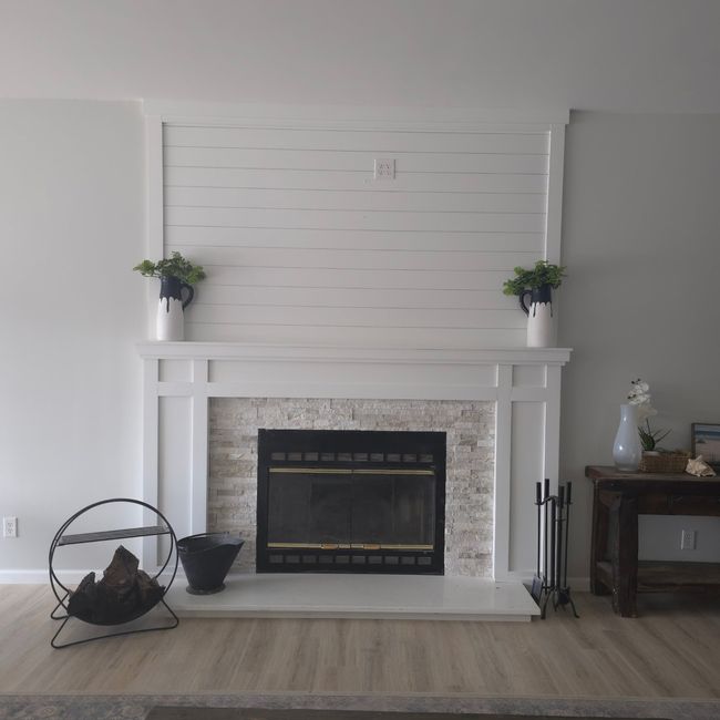 Detailed view of a stone fireplace and wood finished floors | Image 11