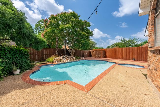 View of swimming pool with a fenced backyard, an in-ground hot tub, and a patio area | Image 26
