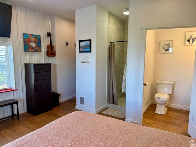 Bedroom featuring wood-type floors, and ensuite bathroom | Image 11