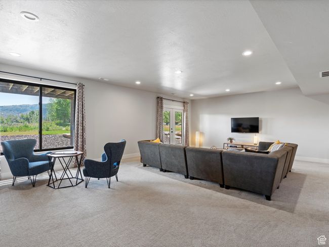 Living area with light carpet, recessed lighting, healthy amount of natural light, and baseboards | Image 45