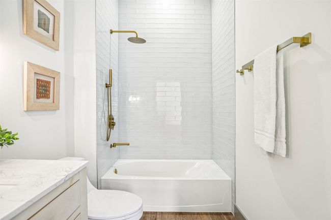 Full bathroom with shower / bath combination, vanity, and dark wood-style floors | Image 19