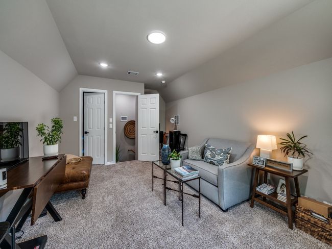 Living area featuring carpet floors, vaulted ceiling, a desk, and baseboards | Image 22