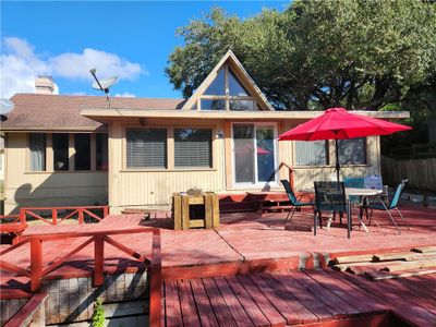 Backside of house with many decks and picnic areas to enjoy the waterfront. Shady afternoon to barbeque and fish and just relax. | Image 1