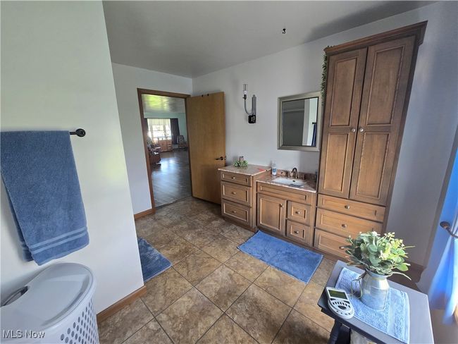 Bathroom featuring baseboards and vanity | Image 36