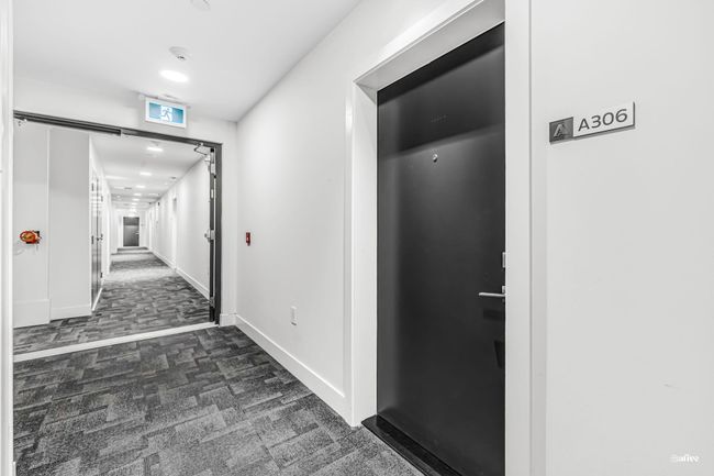 Corridor featuring dark colored carpet and baseboards | Image 20