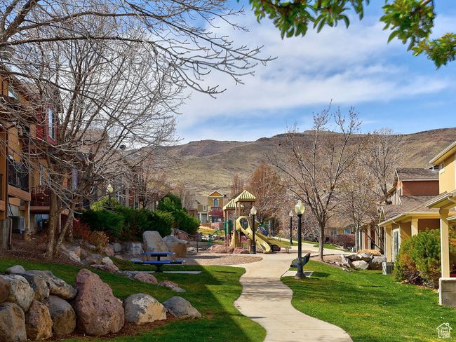 View of community featuring a lawn, a mountain view, and playground community | Image 13