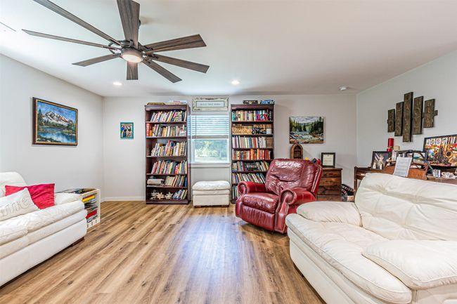Living area featuring wood finished floors, ceiling fan, and recessed lighting | Image 7