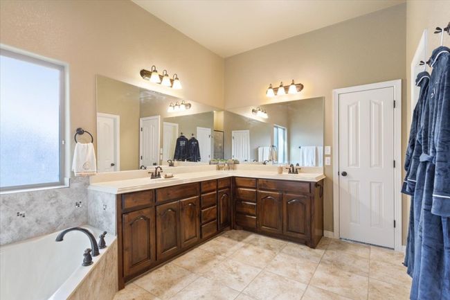 Bathroom featuring a sink, a bath, double vanity, and tile patterned flooring | Image 21