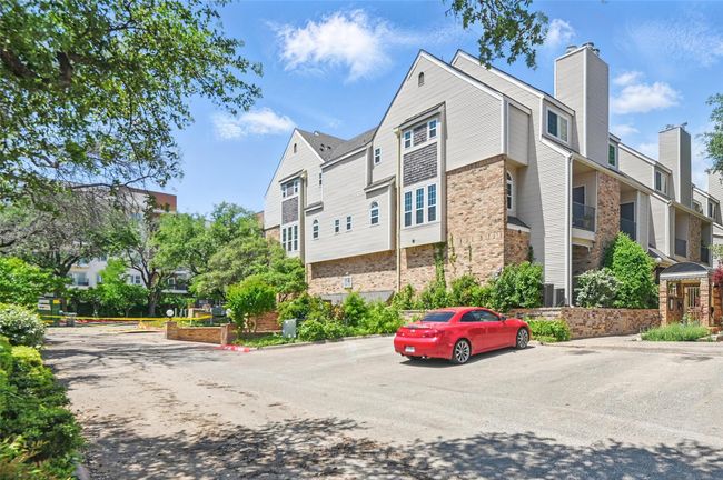 View of building exterior featuring uncovered parking and a residential view | Image 28