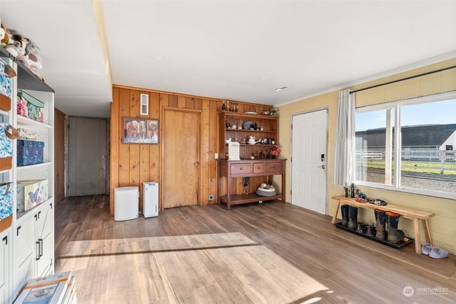 The lower level has a convenient access to the outdoors, making it an ideal hub for reaching the farm and shop buildings. With ample space, it also serves as a fantastic area for crafting or pursuing creative projects | Image 22