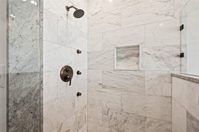 Bathroom featuring a tile shower | Image 26