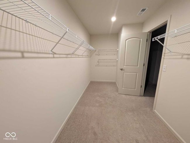 spacious closet with carpet floors and visible vents | Image 42