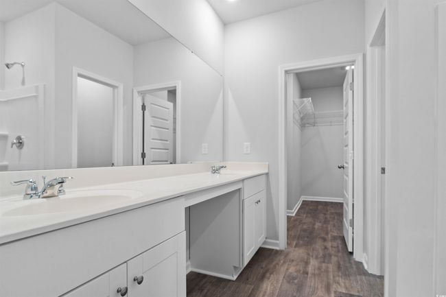 Empty room with dark wood-style flooring, visible vents, recessed lighting, and baseboards | Image 6