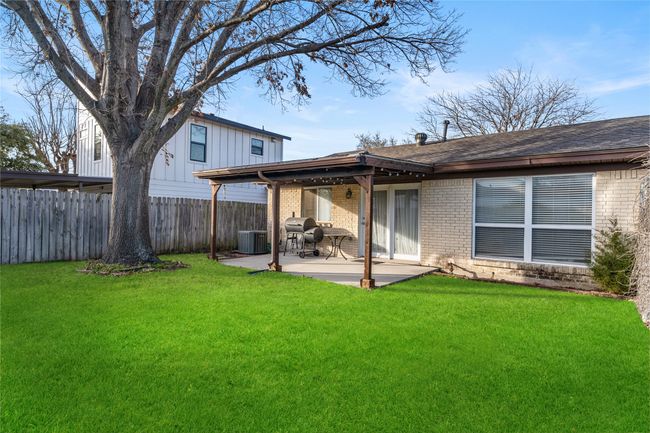 Back of house featuring central AC unit, a patio area, and a lawn | Image 26