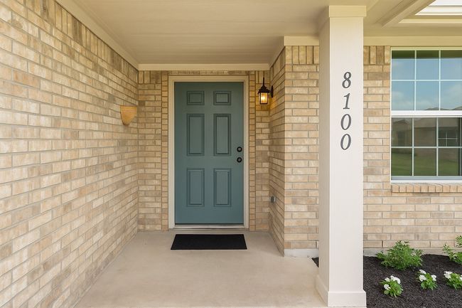 View of exterior entry featuring brick siding and a porch | Image 5