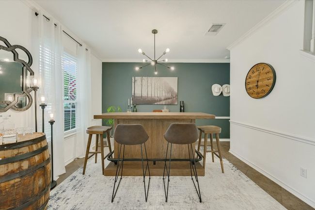 Bar with ornamental molding, a chandelier, and baseboards | Image 5