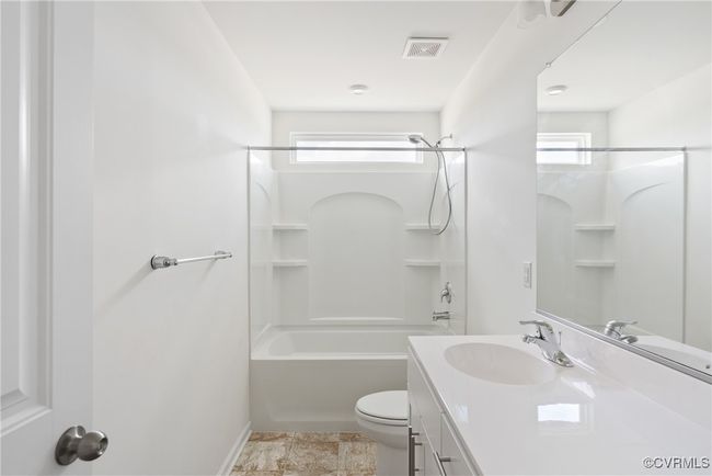 Full bath with visible vents, vanity, baseboards, toilet, and shower combination | Image 25